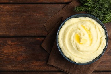 Freshly cooked homemade mashed potatoes on wooden table, top view. Space for text