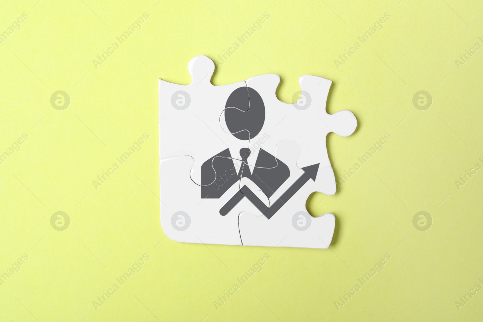 Image of Business development concept. White puzzle pieces on yellow background, top view 