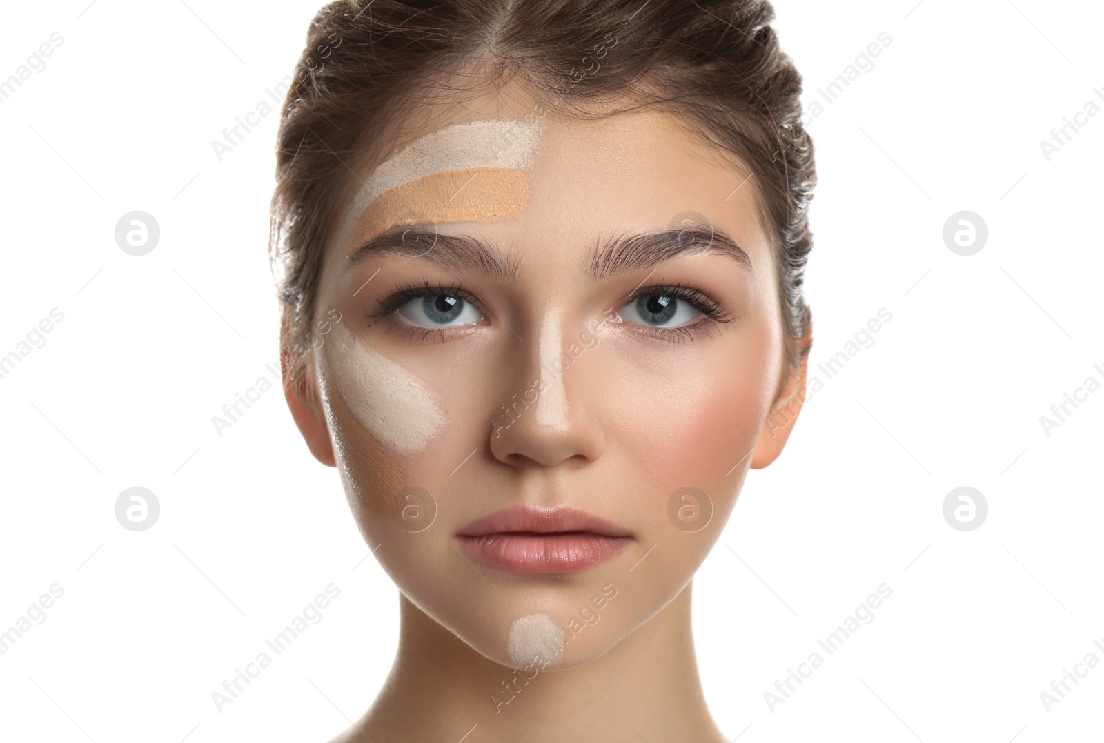 Photo of Beautiful girl on white background. Using concealer and foundation for face contouring