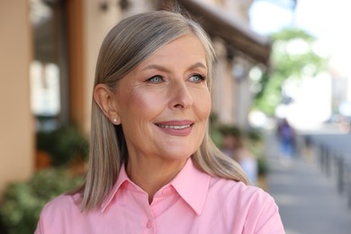 Photo of Portrait of beautiful happy senior woman outdoors