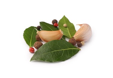 Photo of Aromatic bay leaves and spices isolated on white