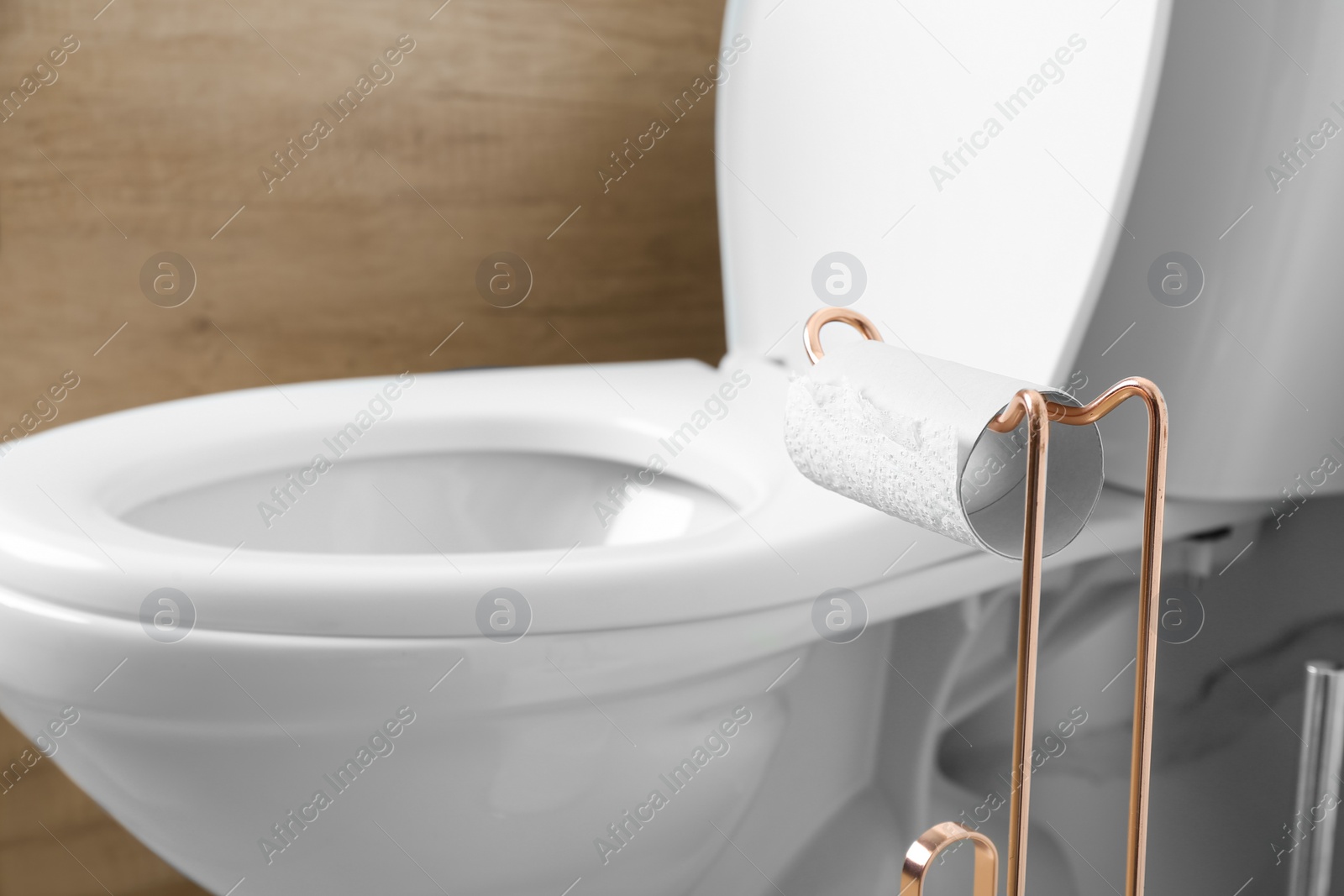 Photo of Holder with empty toilet paper roll in bathroom