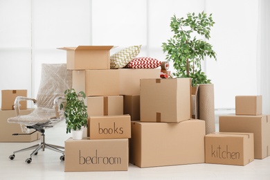 Photo of Pile of moving boxes in empty room