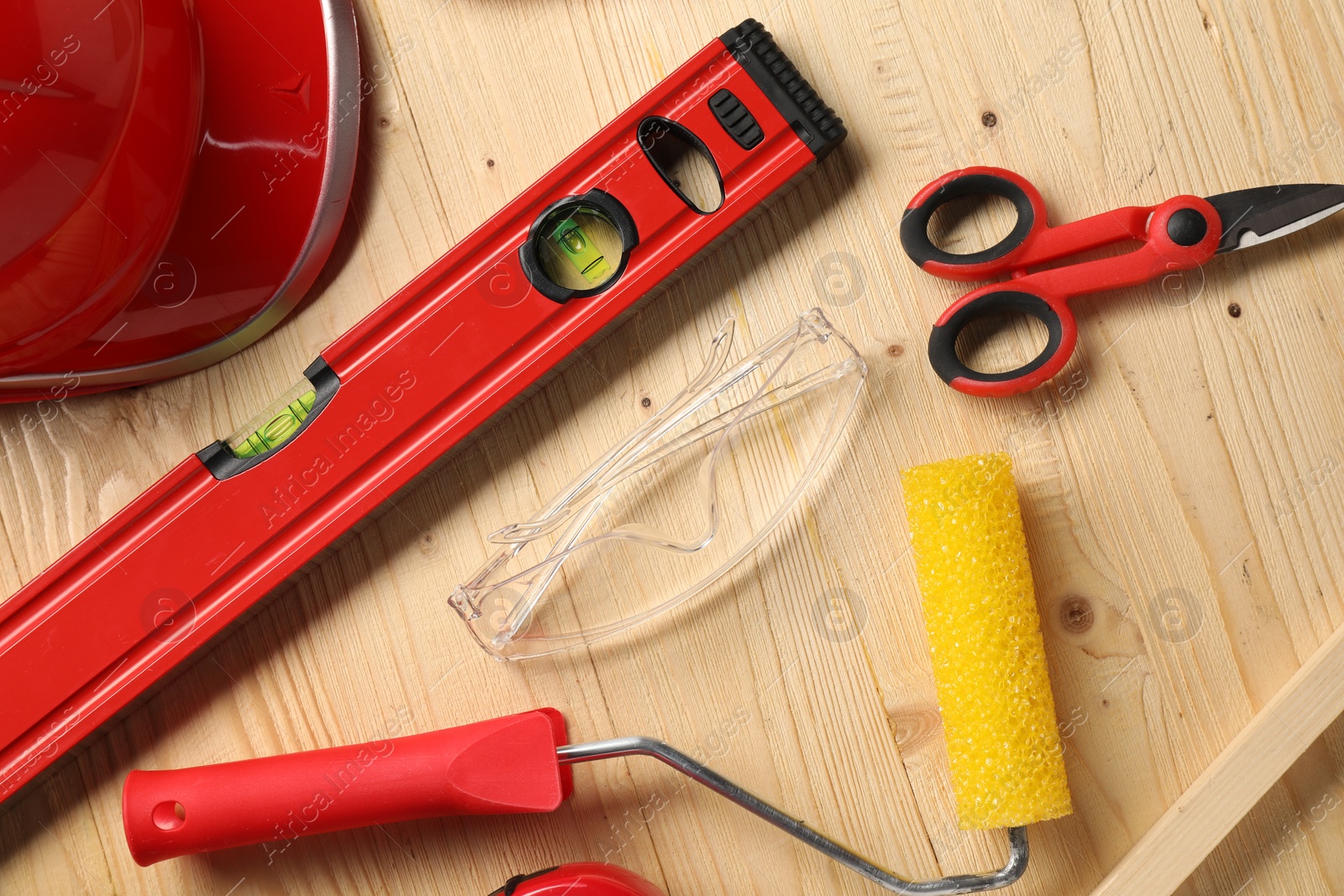 Photo of Flat lay composition with building level and other different construction tools on wooden background