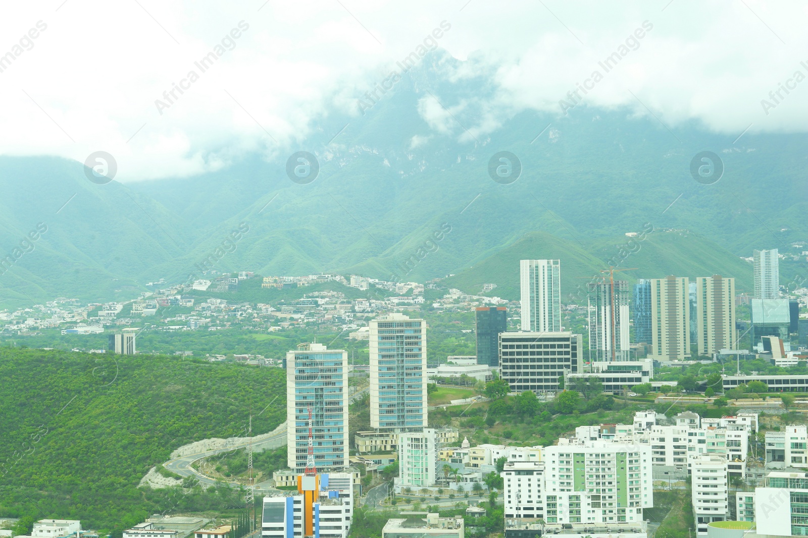 Photo of Beautiful view on city with many buildings under thick fog