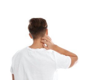 Young man scratching neck on white background. Annoying itch