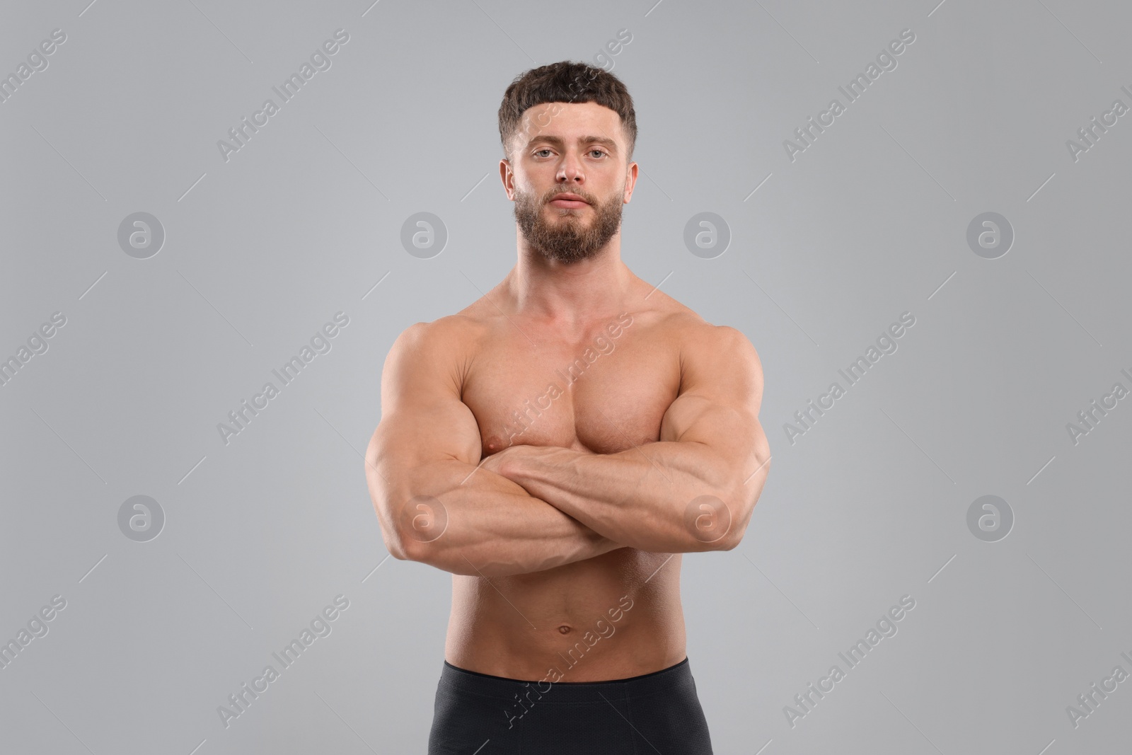 Photo of Handsome muscular man on light grey background. Sexy body