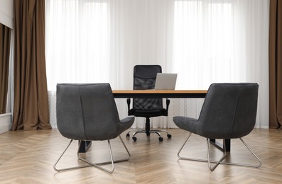 Director's office with large wooden table and comfortable armchairs. Interior design