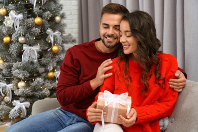 Image of Lovely couple celebrating Christmas together at home