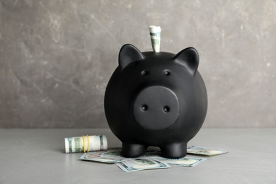 Photo of Piggy bank with money against color background