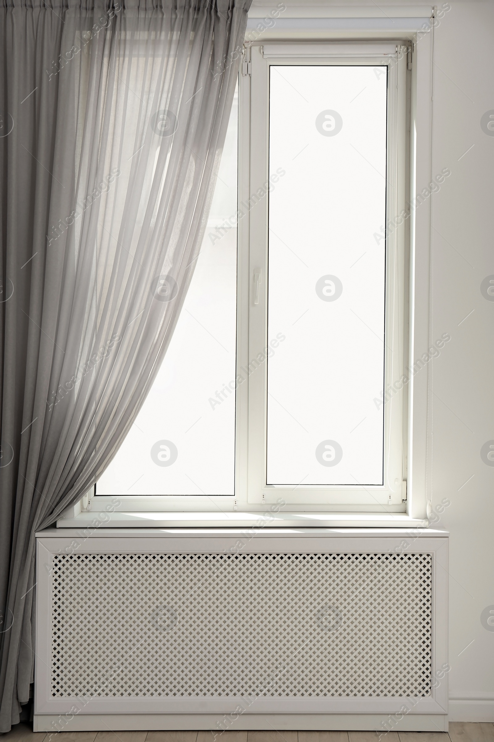 Photo of Light room with window and open curtains. Home interior