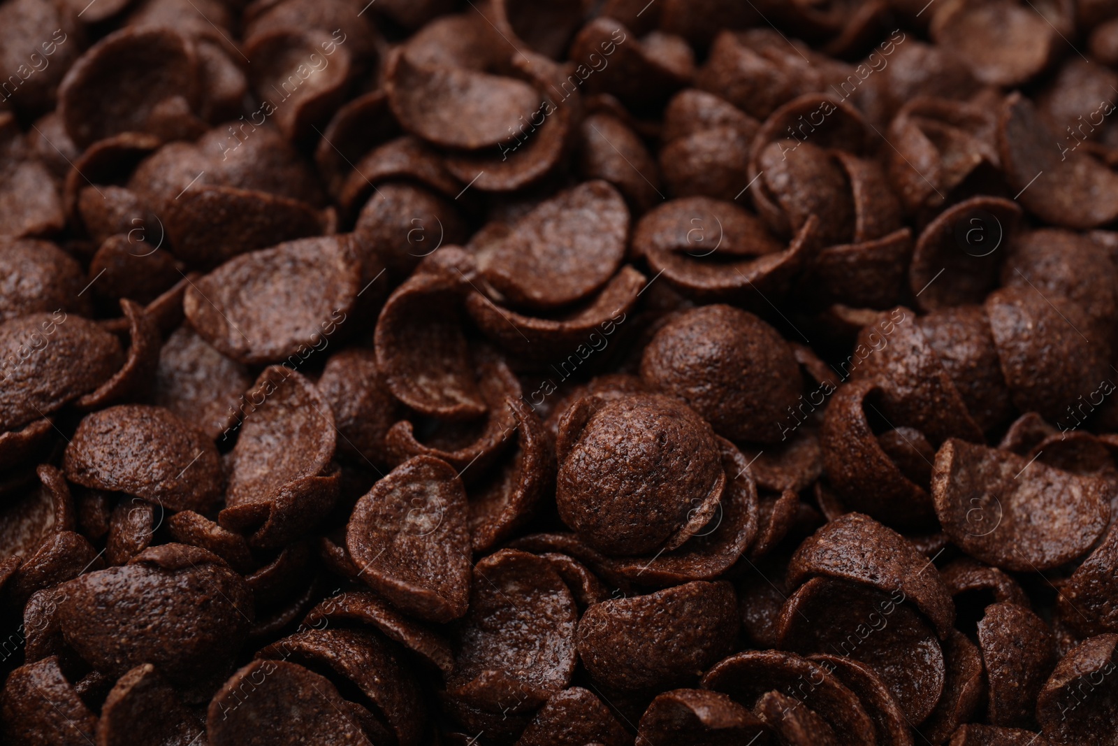 Photo of Breakfast cereal. Tasty chocolate corn flakes as background, closeup