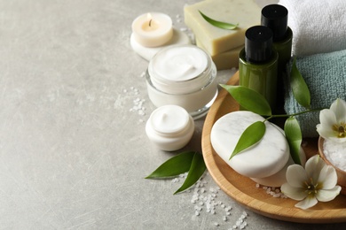 Photo of Spa composition with skin care products on textured table, closeup. Space for text