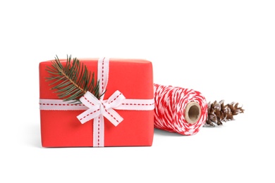 Photo of Beautifully wrapped gift box and rope on white background