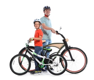 Photo of Portrait of father and his son with bicycles on white background