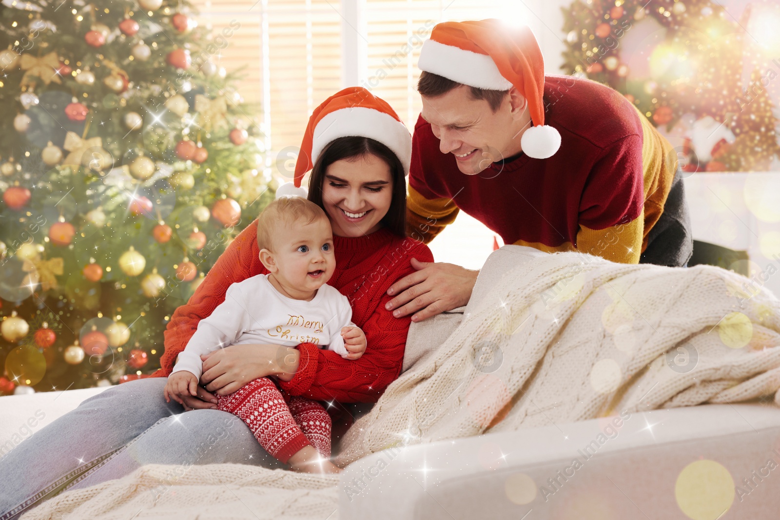 Image of Happy couple with cute baby on sofa in room decorated for Christmas. Magical festive atmosphere