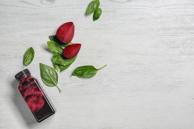 Flat lay composition with beet smoothie on white wooden background with space for text