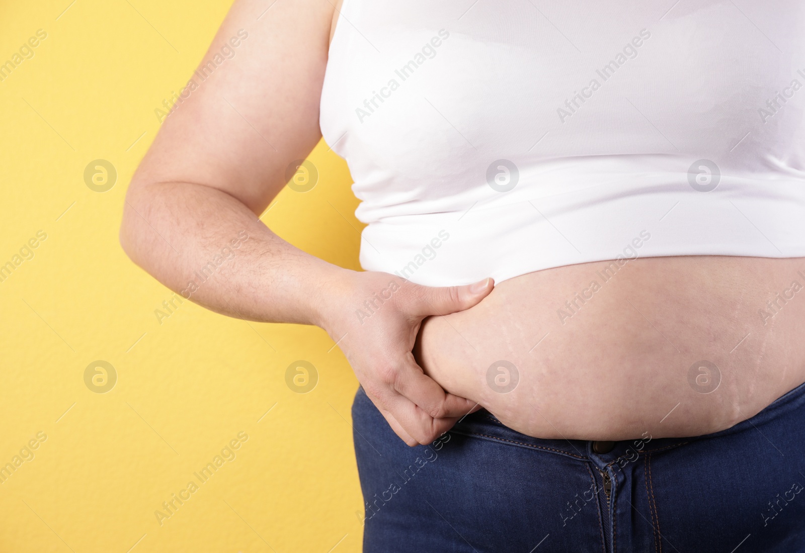 Photo of Overweight woman on color background, closeup. Obesity and weight loss