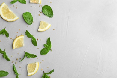 Fresh mint with sliced lemon and sugar on grey background, flat lay. Space for text