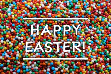 Image of Text Happy Easter and bright colorful sprinkles as background, top view. Confectionery decor