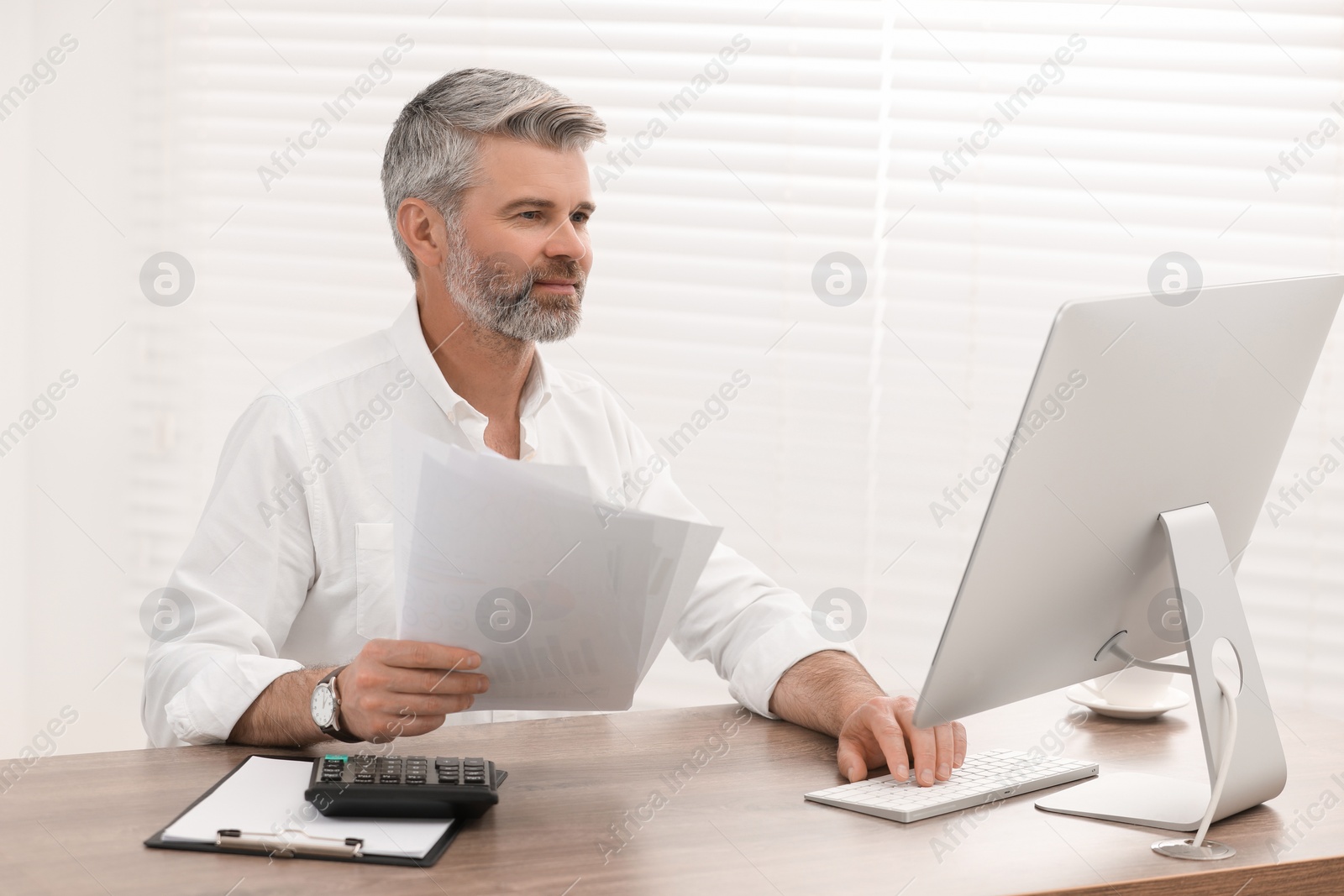 Photo of Professional accountant working at wooden desk in office