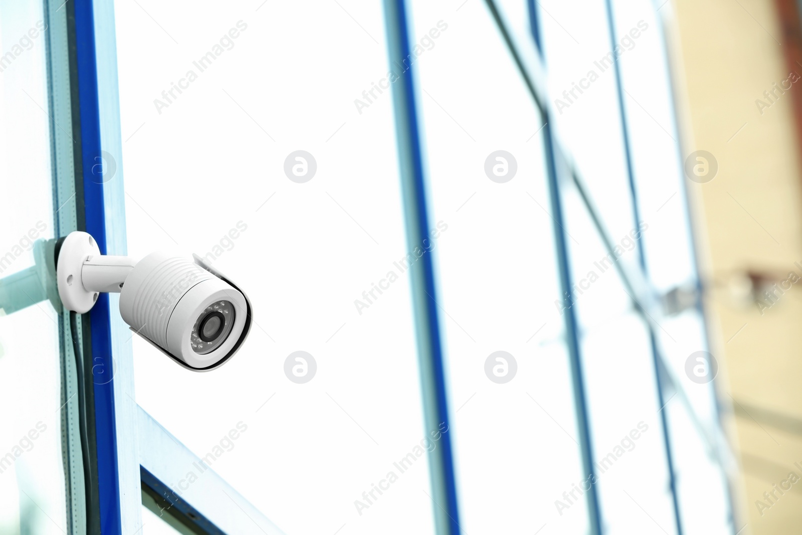 Photo of Modern security CCTV camera on wall outdoors