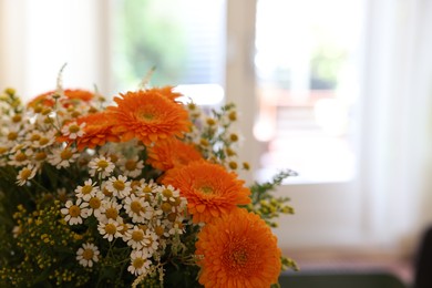 Fresh bouquet of chamomile and calendula flowers, closeup. Space for text