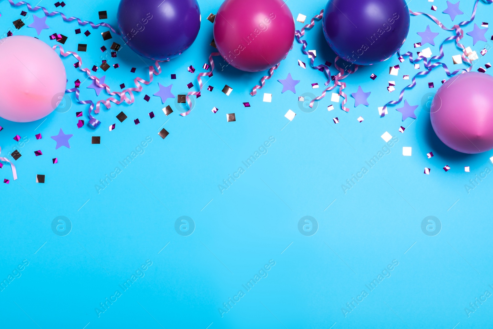 Photo of Many balloons and confetti on light blue background, flat lay with space for text. Birthday decor