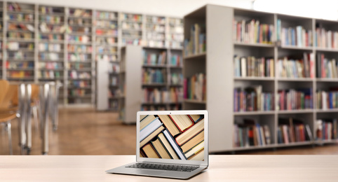 Image of Digital library concept. Modern laptop on table indoors