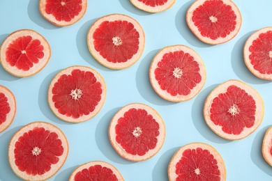 Fresh sliced ripe grapefruit on color background, flat lay