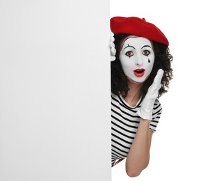 Funny mime with blank poster posing on white background