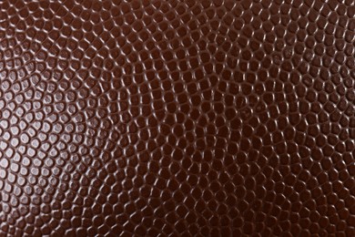 Photo of Texture of American football ball leather as background, closeup