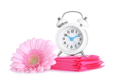 Photo of Clock, menstrual pads and flower on white background. Gynecology concept