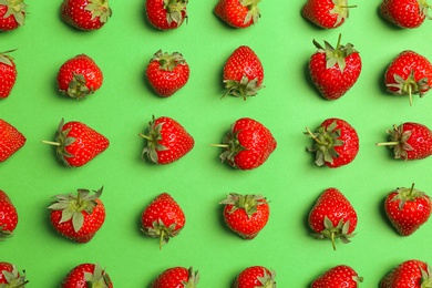 Flat lay composition with with tasty ripe strawberries on color background