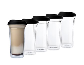 Image of Empty reusable glass cups and one with aromatic coffee on white background