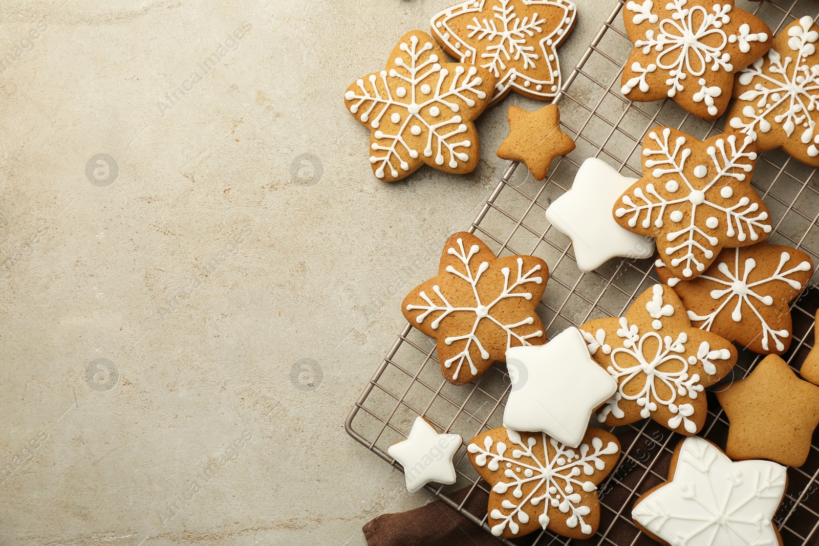 Photo of Tasty Christmas cookies with icing on light table, flat lay. Space for text