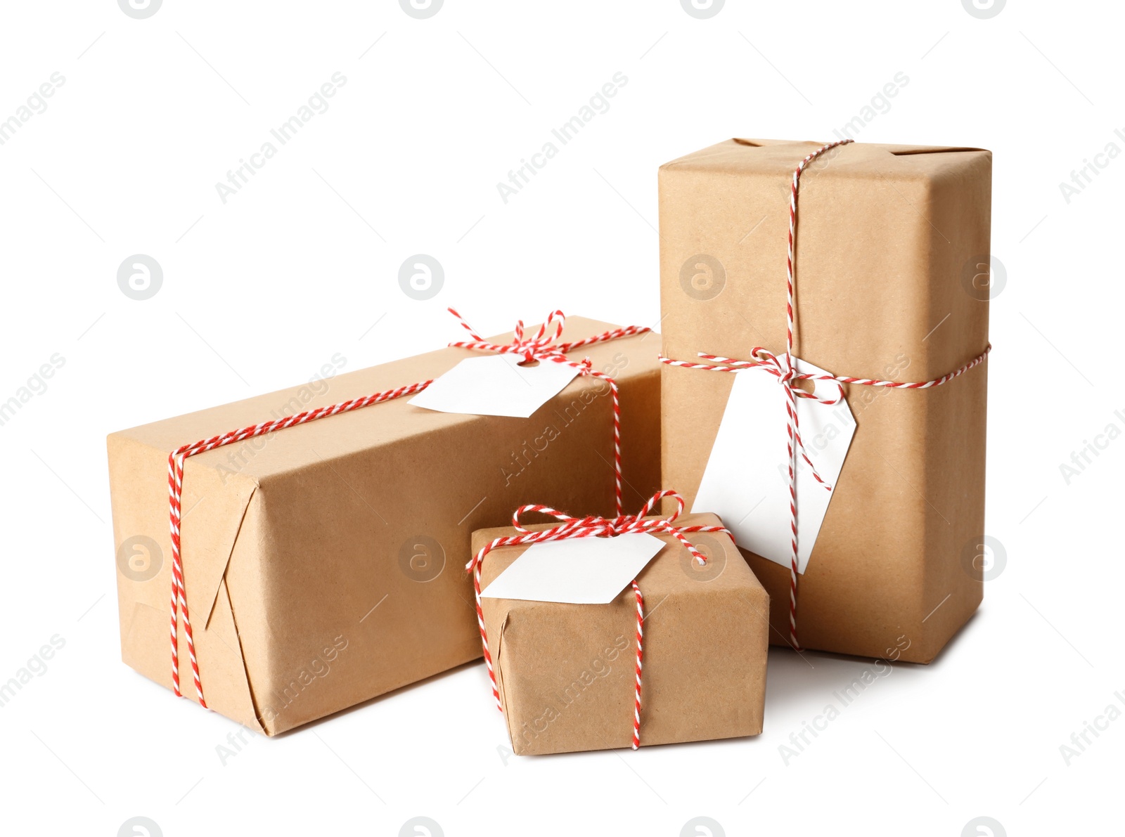 Photo of Gift boxes wrapped in kraft paper with tags on white background