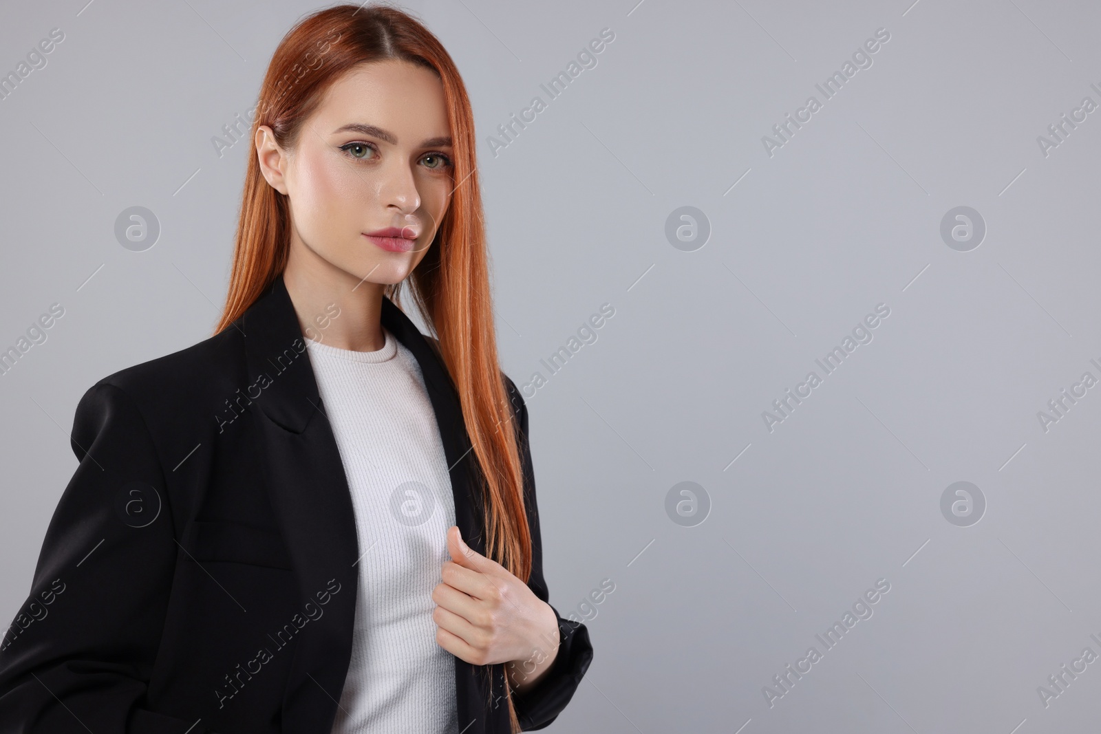 Photo of Portrait of beautiful young woman on light gray background, space for text