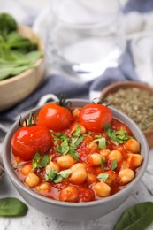 Delicious chickpea curry in bowl on table, closeup