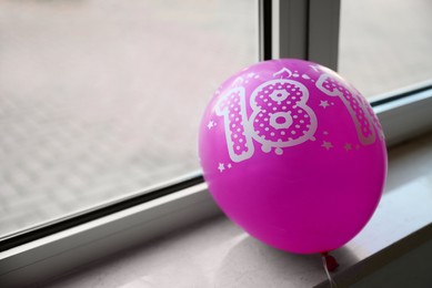 Photo of Pink balloon with number 18 as birthday candles on windowsill indoors, space for text. Coming of age party