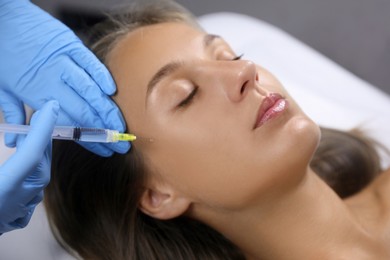 Photo of Beautiful woman getting facial injection in salon