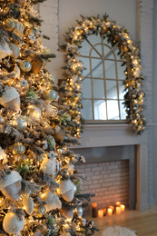 Closeup view of beautiful decorated Christmas tree in living room