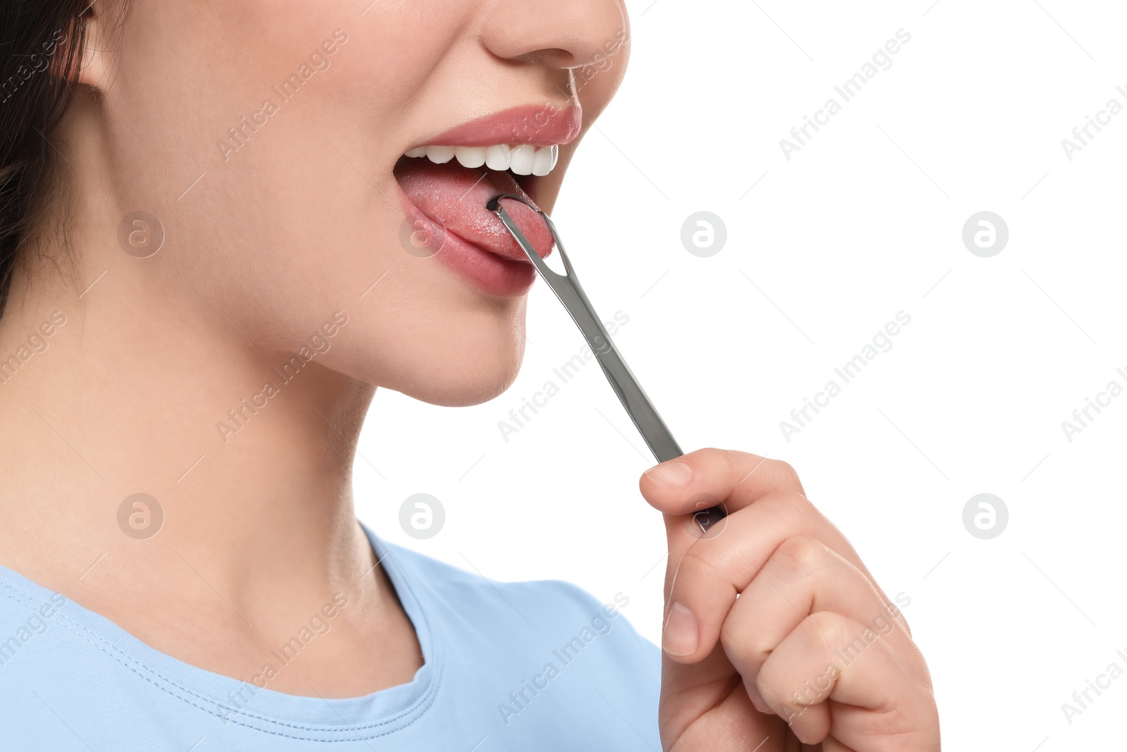 Photo of Woman brushing her tongue with cleaner on white background, closeup
