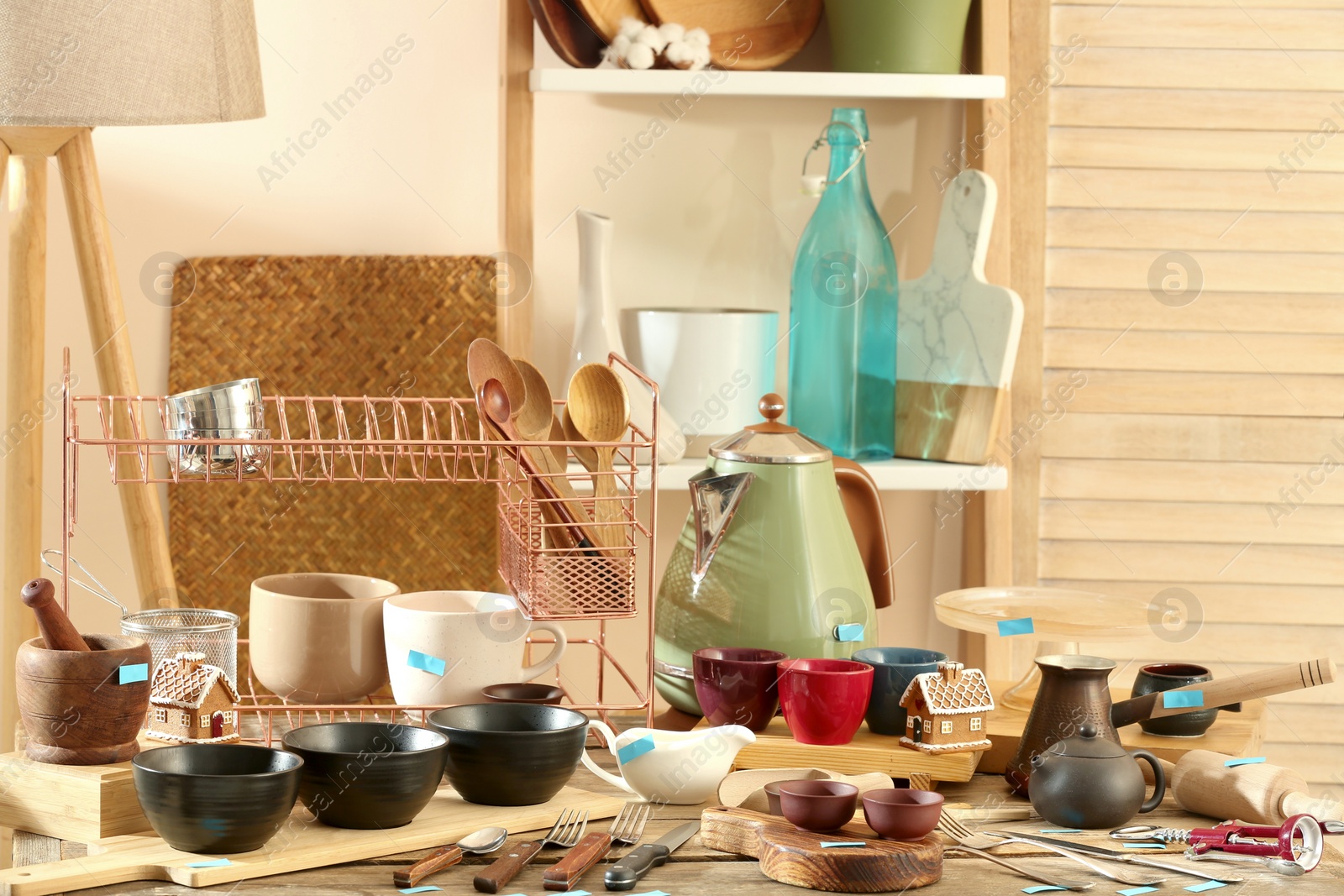 Photo of Many different cooking utensils in room. Garage sale