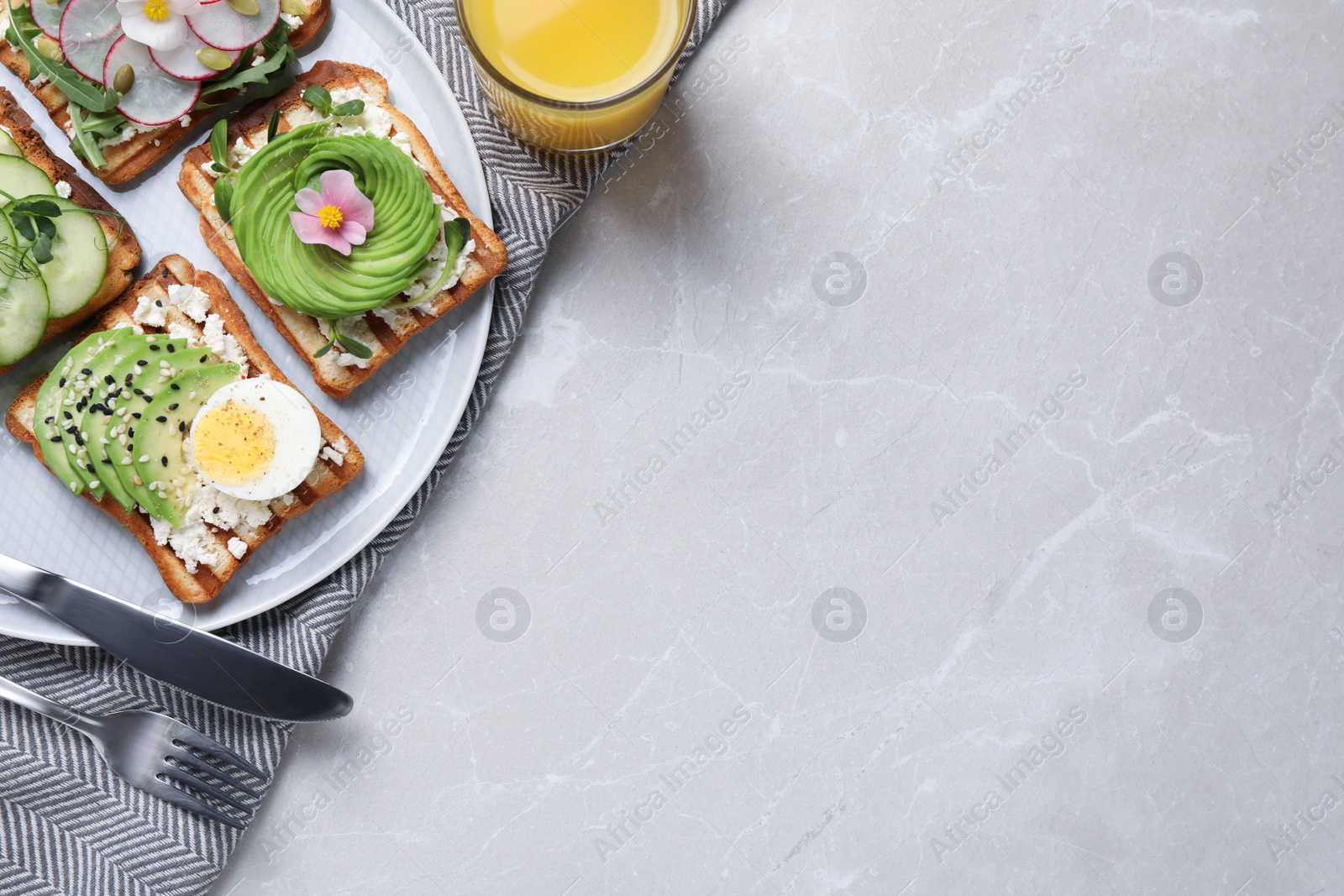 Photo of Different delicious sandwiches on light marble table, flat lay. Space for text