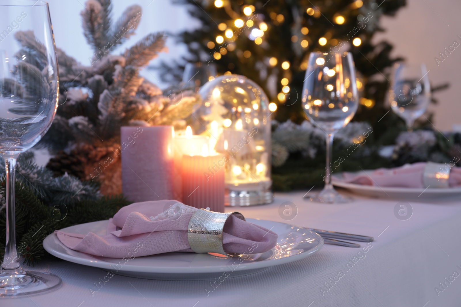 Photo of Beautiful festive place setting with Christmas decor on table indoors