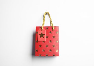 Red shopping paper bag with star pattern isolated on white