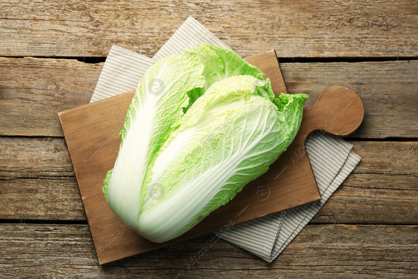 Photo of Fresh ripe Chinese cabbage on wooden table, top view