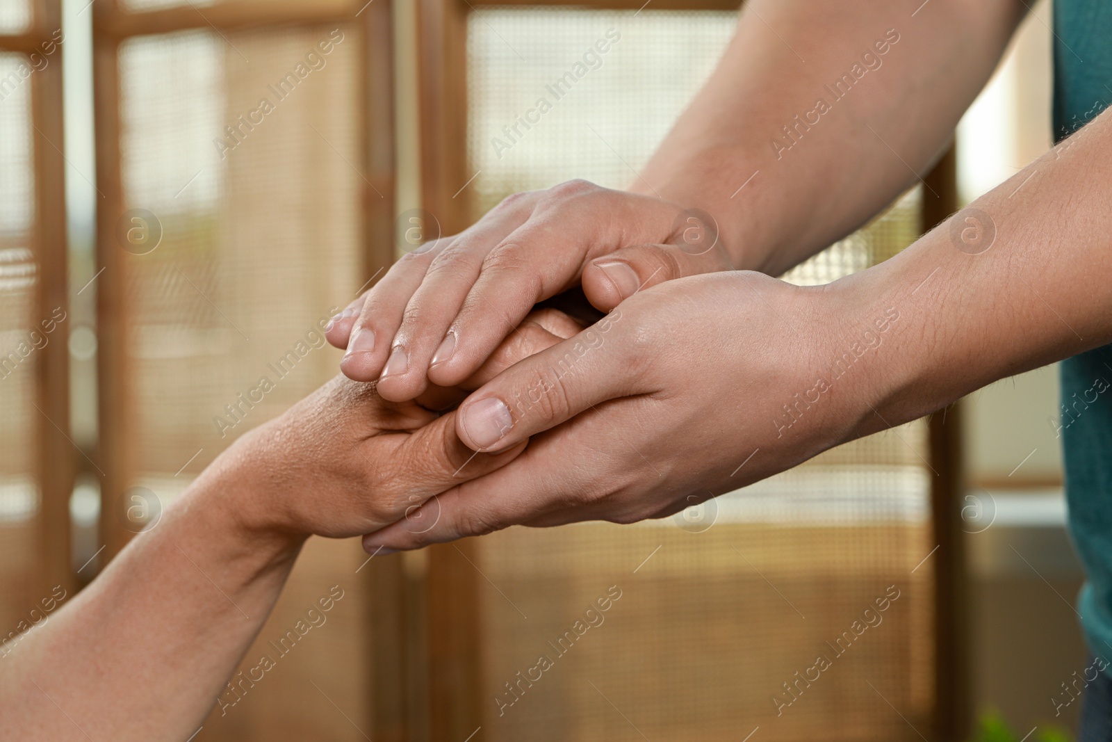 Photo of Caregiver helping elderly woman at home, closeup