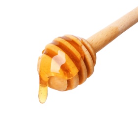 Honey dripping from dipper on white background